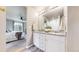 Bright bathroom featuring a granite countertop, double sinks, walk-in shower, and wood-look flooring at 1933 Villageview Ln, Castle Rock, CO 80104