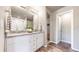 Elegant bathroom featuring double sinks, granite countertop, white cabinetry, and a walk-in shower at 1933 Villageview Ln, Castle Rock, CO 80104