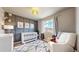 This Bedroom features modern decor, including a crib, changing table, and cozy chair at 1933 Villageview Ln, Castle Rock, CO 80104