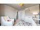 The Bedroom offers a chair, modern changing table, and ample closet space at 1933 Villageview Ln, Castle Rock, CO 80104