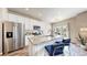 Well-equipped kitchen with an island and bar seating, stainless steel appliances, and white cabinetry at 1933 Villageview Ln, Castle Rock, CO 80104