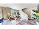 Inviting living room features wood floors, neutral walls, large windows, and stylish decor at 1933 Villageview Ln, Castle Rock, CO 80104