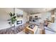 Open living space with a fireplace, kitchen island with bar stools, and dining area at 1933 Villageview Ln, Castle Rock, CO 80104