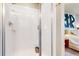 Clean and bright walk-in shower with white tiles, glass door, and modern fixtures in bathroom at 1933 Villageview Ln, Castle Rock, CO 80104