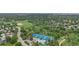 Aerial view featuring community amenities including a pool, tennis courts and grassy open space at 8236 E Phillips Pl, Centennial, CO 80112