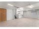 A finished basement features carpeted floors and a built-in bar area with white cabinets and shelving at 8236 E Phillips Pl, Centennial, CO 80112