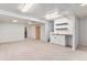 Basement featuring neutral carpet, a sink, a shelving closet, and storage closets at 8236 E Phillips Pl, Centennial, CO 80112