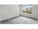 Bedroom with neutral carpet, white walls, and a large window offering exterior view at 8236 E Phillips Pl, Centennial, CO 80112