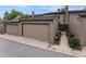 Attached garages in a row with neutral paint and visible house numbers and landscape alongside at 8236 E Phillips Pl, Centennial, CO 80112