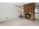 Cozy living room featuring a brick fireplace and a view to the second story at 8236 E Phillips Pl, Centennial, CO 80112