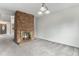 Cozy living room with a brick fireplace and recessed lighting, ready to be furnished at 8236 E Phillips Pl, Centennial, CO 80112