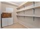 Pantry with wooden shelves and cabinets offering ample storage space in a practical design at 8236 E Phillips Pl, Centennial, CO 80112