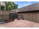 Back patio featuring stone tiling and an iron gate with a fence surrounding the yard at 8236 E Phillips Pl, Centennial, CO 80112