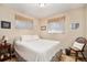 Comfortable bedroom with neutral walls, wood chair, and windows at 3083 S Xanthia St, Denver, CO 80231