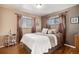 Cozy bedroom features hardwood floors, a chandelier, and stylish neutral-toned decor at 3083 S Xanthia St, Denver, CO 80231