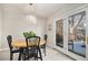 Cozy dining area with a stylish chandelier, a wood table with black chairs and access to the patio at 3083 S Xanthia St, Denver, CO 80231