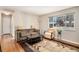Bright living room with a large window, hardwood floors, comfortable seating, and a stylish area rug at 3083 S Xanthia St, Denver, CO 80231