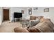 Spacious living room with a large brown sofa, glass table, and plush carpet at 3083 S Xanthia St, Denver, CO 80231