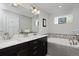 Elegant bathroom featuring a double vanity, soaking tub, and modern fixtures at 719 Robert St, Longmont, CO 80503