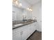 Bright bathroom featuring double sinks, granite countertops, and wood look floors at 719 Robert St, Longmont, CO 80503