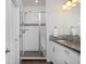 Bright bathroom with double sinks, granite countertops, and a glass enclosed shower at 719 Robert St, Longmont, CO 80503