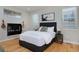 Bedroom featuring hardwood floors, decorative wall art and stylish furnishings at 719 Robert St, Longmont, CO 80503