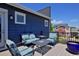 Relaxing deck area with comfortable outdoor seating and views of the community at 719 Robert St, Longmont, CO 80503