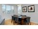 Bright dining room with a large wooden table, comfortable chairs, and natural light streaming through the windows at 719 Robert St, Longmont, CO 80503