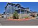 Inviting multi-story home with blue siding, two-car garage, and charming landscaping at 719 Robert St, Longmont, CO 80503