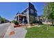 Modern two-story home features a combination of blue siding and stone accents and a balcony at 719 Robert St, Longmont, CO 80503