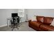 Bright office space with a sleek glass desk, ergonomic chair, and comfortable couch at 719 Robert St, Longmont, CO 80503