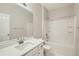 Bright bathroom with white vanity, white tile flooring, and shower over tub at 13667 Valentia St, Thornton, CO 80602