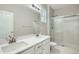 Bathroom featuring dual sink vanity with white countertops and a glass-enclosed shower at 13667 Valentia St, Thornton, CO 80602