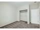 This bedroom features neutral walls, carpet and an open closet with metal shelving and a white door at 13667 Valentia St, Thornton, CO 80602