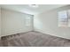 Neutral bedroom with plush carpet, ample natural light from the two windows, and grey walls at 13667 Valentia St, Thornton, CO 80602