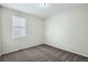 Neutral bedroom with plush carpet, and a large window providing natural light at 13667 Valentia St, Thornton, CO 80602