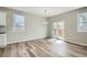 Open-concept dining area featuring stylish flooring, a modern chandelier, and sliding door to the backyard at 13667 Valentia St, Thornton, CO 80602