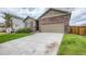 A charming home featuring a brick and siding exterior with an attached two-car garage and concrete driveway at 13667 Valentia St, Thornton, CO 80602