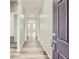 Hallway showcasing wood-look flooring and neutral wall paint, with a view of the home's open layout at 13667 Valentia St, Thornton, CO 80602