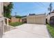 Backyard with two car detached garage, brick wall, and grassy lawn at 848 Harrison St, Denver, CO 80206