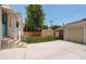 Backyard features a grassy lawn, brick wall, and a two-car garage at 848 Harrison St, Denver, CO 80206