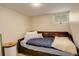 Cozy bedroom with a daybed, blue bedding, and a small window for natural light at 848 Harrison St, Denver, CO 80206