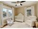 Sun-filled Bedroom with dual windows, a plush chair, and a crib for a welcoming space at 848 Harrison St, Denver, CO 80206