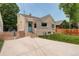 Charming exterior of home with a blue door, stucco, and steps to enter the home at 848 Harrison St, Denver, CO 80206