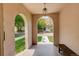 Arched porch featuring stone floors and bench seating with views to the tree lined street at 848 Harrison St, Denver, CO 80206