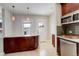 Bright kitchen with tiled flooring, wooden cabinets, and a stainless steel dishwasher for convenience at 848 Harrison St, Denver, CO 80206