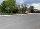 Charming brick home featuring an attached garage, stone chimney, and fenced front yard at 595 W Eastman Ave, Englewood, CO 80110