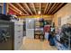 Unfinished basement with open joists, storage shelves, and space for a freezer at 16844 E Lake Pl, Aurora, CO 80016