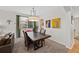 Bright dining room featuring a modern chandelier and a large window offering ample natural light at 16844 E Lake Pl, Aurora, CO 80016