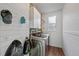 Modern laundry room with shiplap walls, updated appliances, and practical storage solutions at 16844 E Lake Pl, Aurora, CO 80016